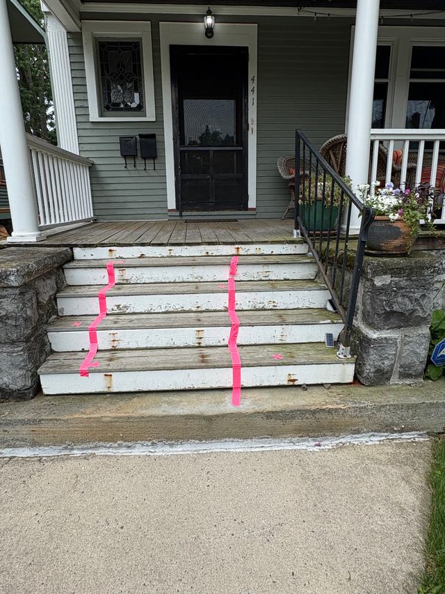 Before: worn, peeling porch steps with a rusty metal railing